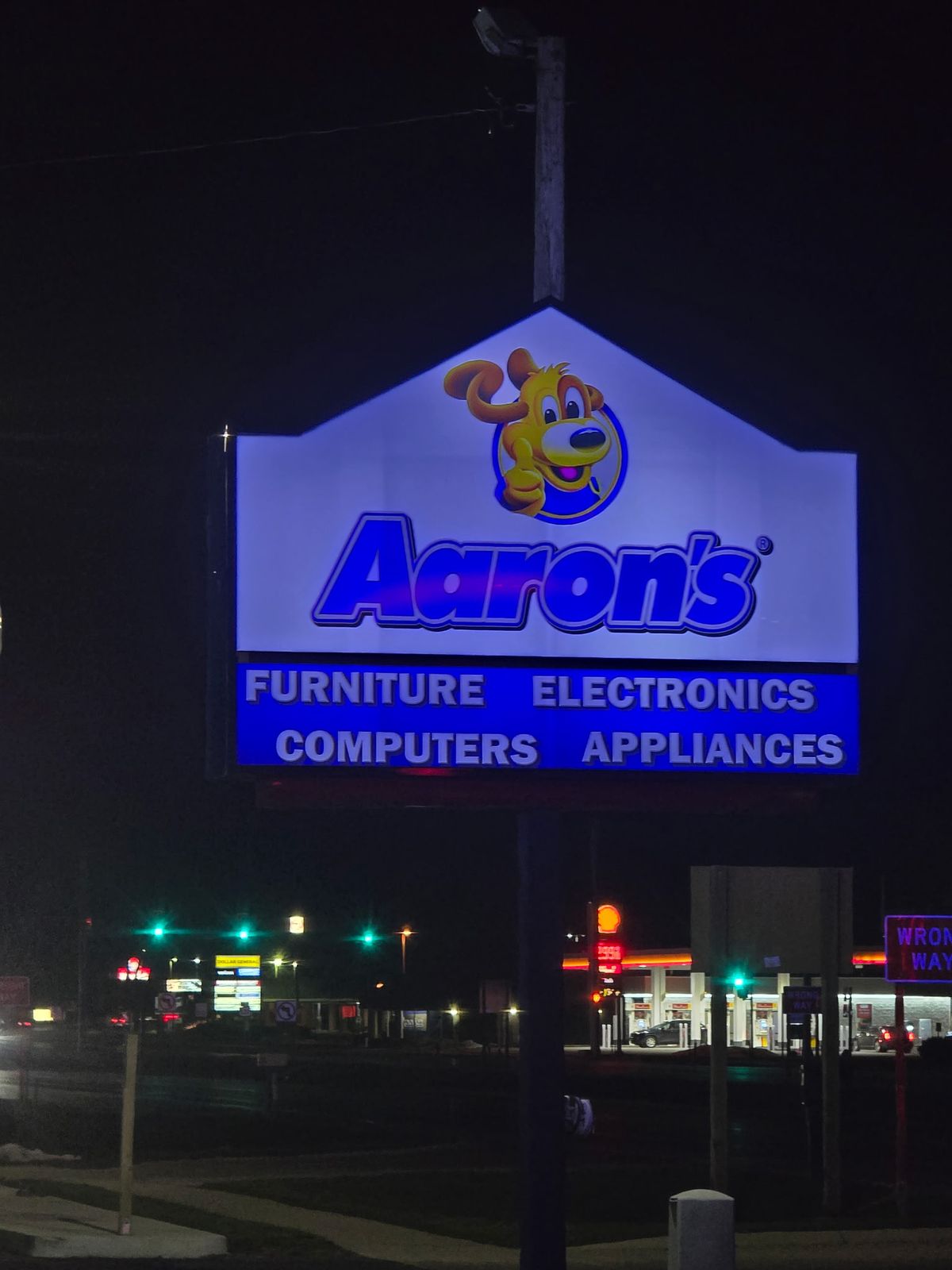 Lit Aaron's pylon sign reading Furniture, Electronics, Computers, Appliances at night