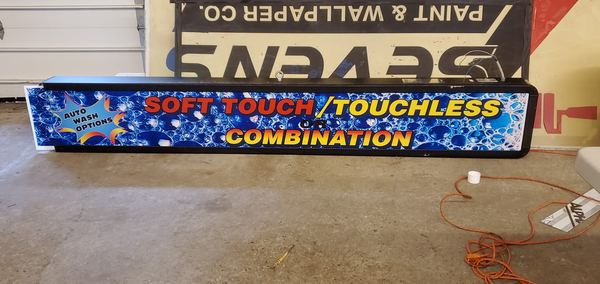 Car wash lightbox sign reading Soft Touch, Touchless or Combination