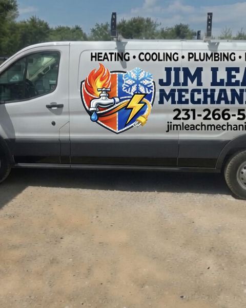 White Ford Transit van with Jim Leach Mechanical heating, cooling, and plumbing side graphics