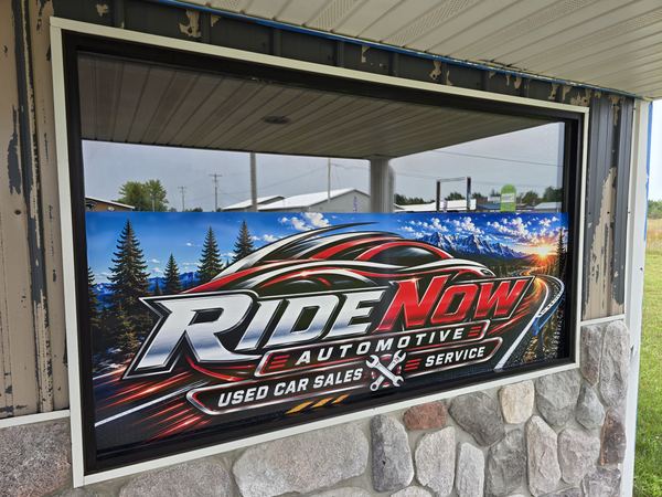RideNow Automotive Used Car Sales and Service graphic displayed in a window