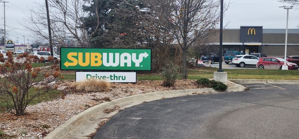 Subway drive-thru monument sign beside a driveway