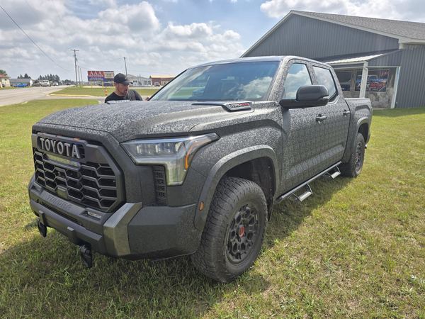 Toyota Tundra TRD Pro pickup in a textured black wrap, seen from the front
